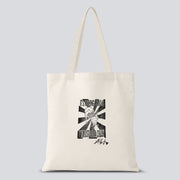 White tote bag with a hand crafted stamp design of a hand crushing an ice cream cone with text saying "It's nothing serious I've just gotta crush" on it
