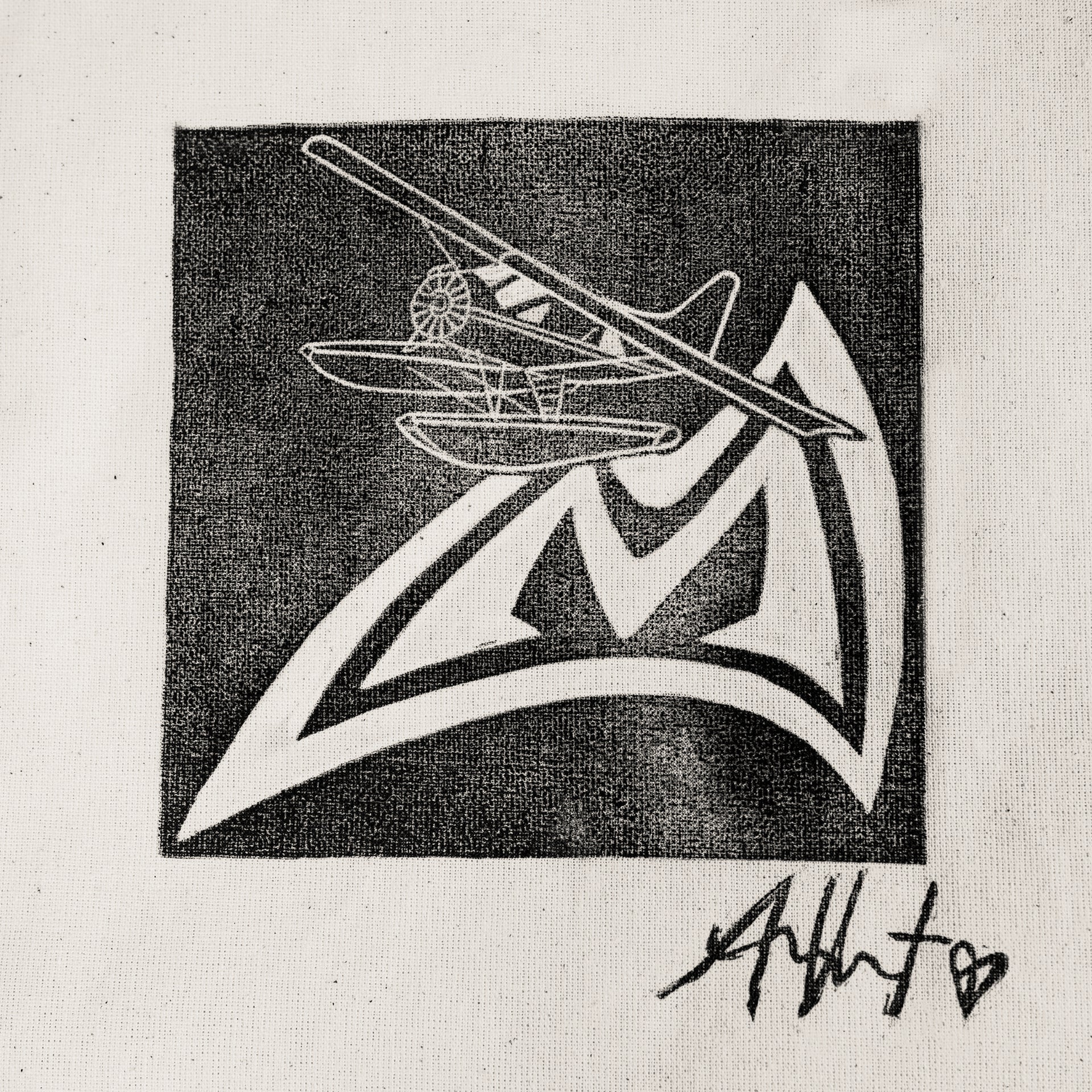 Black and white hand crafted stamp design of an airplane on the Mad Rock  logo with Allison Vest's signature below.