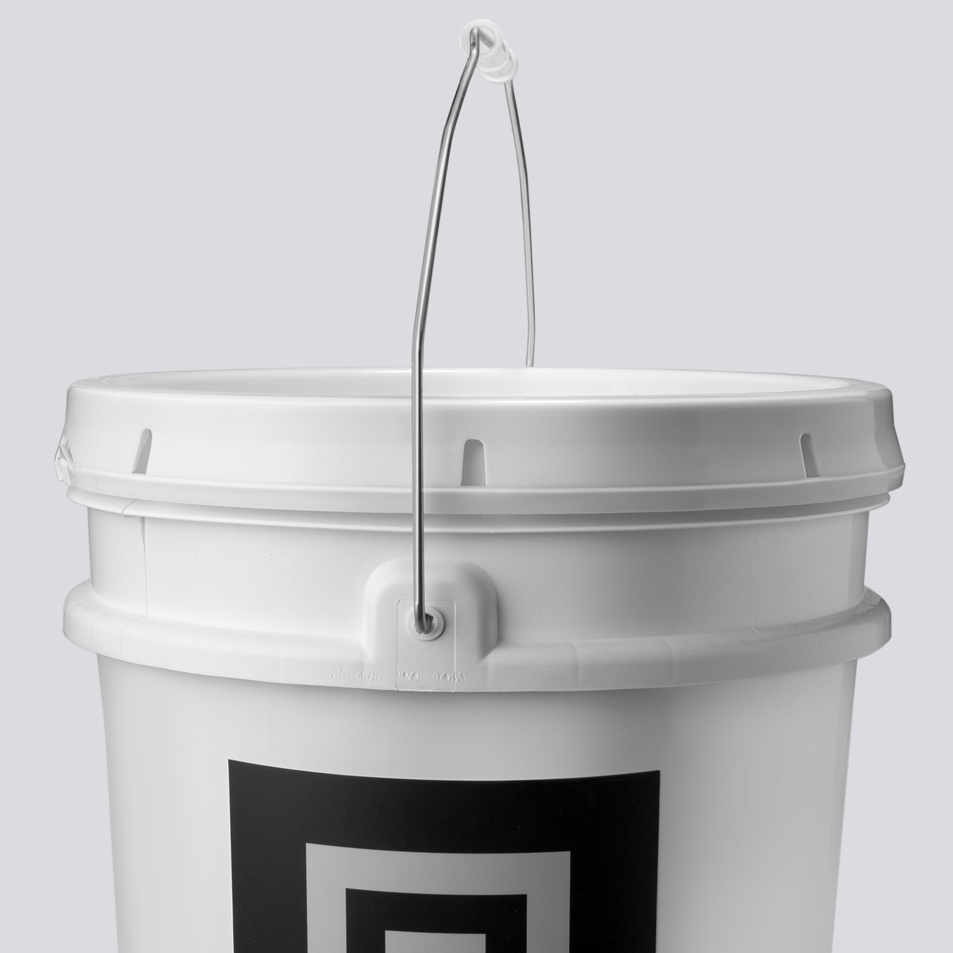 A close up of the lid of a white bucket filled with chalk