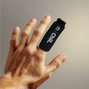 A black hot/cold finger sleeve with 'Crux' and 'Chill' text on it on a hand.