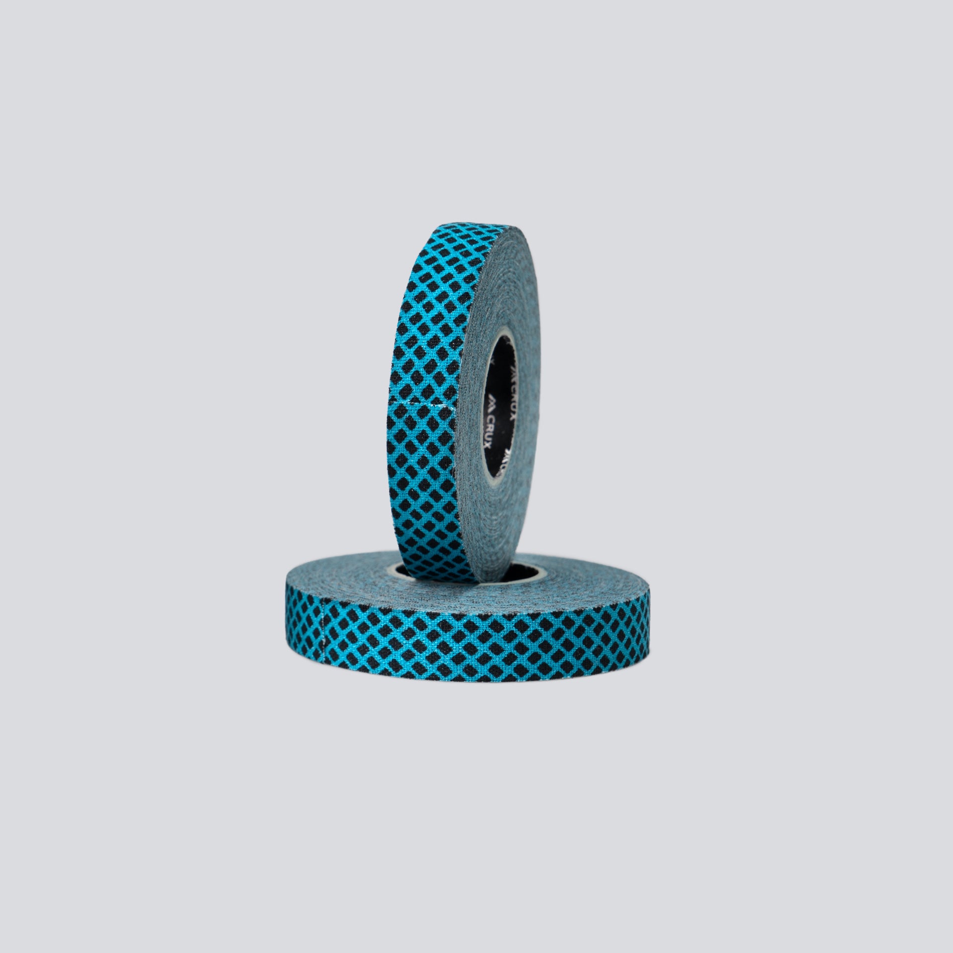 Two rolls of blue and gray tape on a light gray background