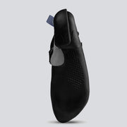 Bottom view of a black climbing shoe with gray and blue accents on a light gray background