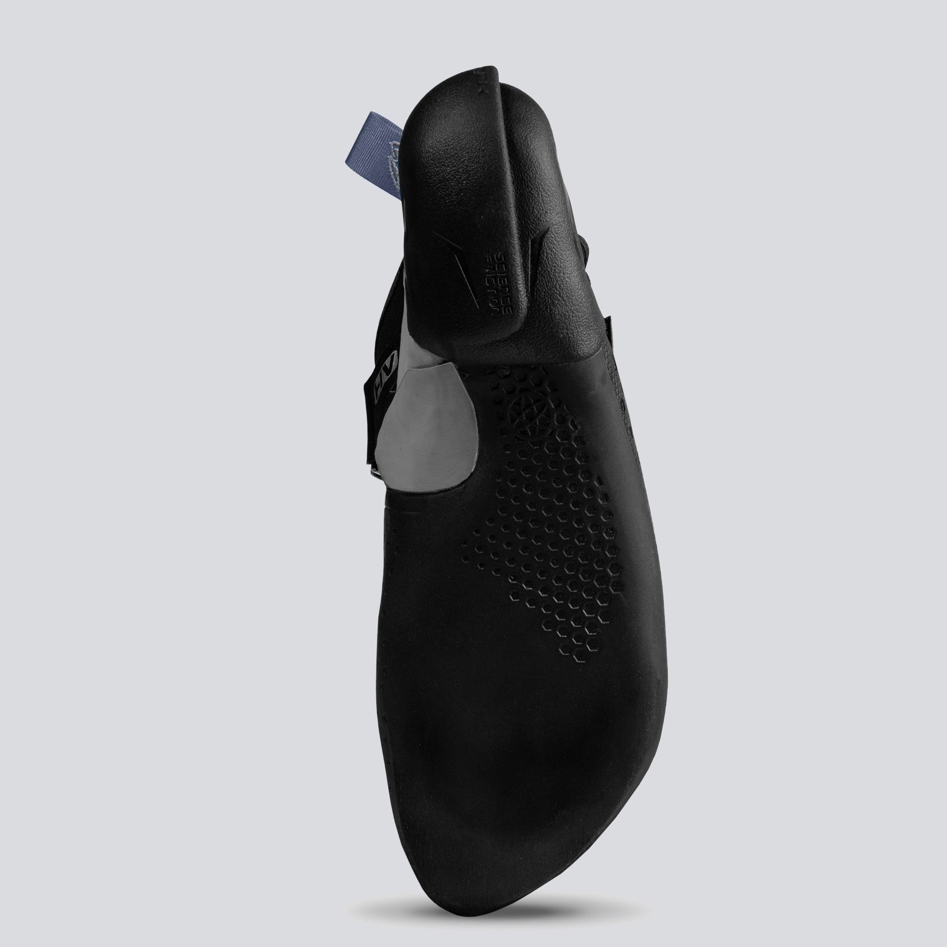 Bottom view of a black climbing shoe with gray and blue accents on a light gray background
