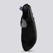 Bottom of a black climbing shoe with gray and teal accents on a light gray background