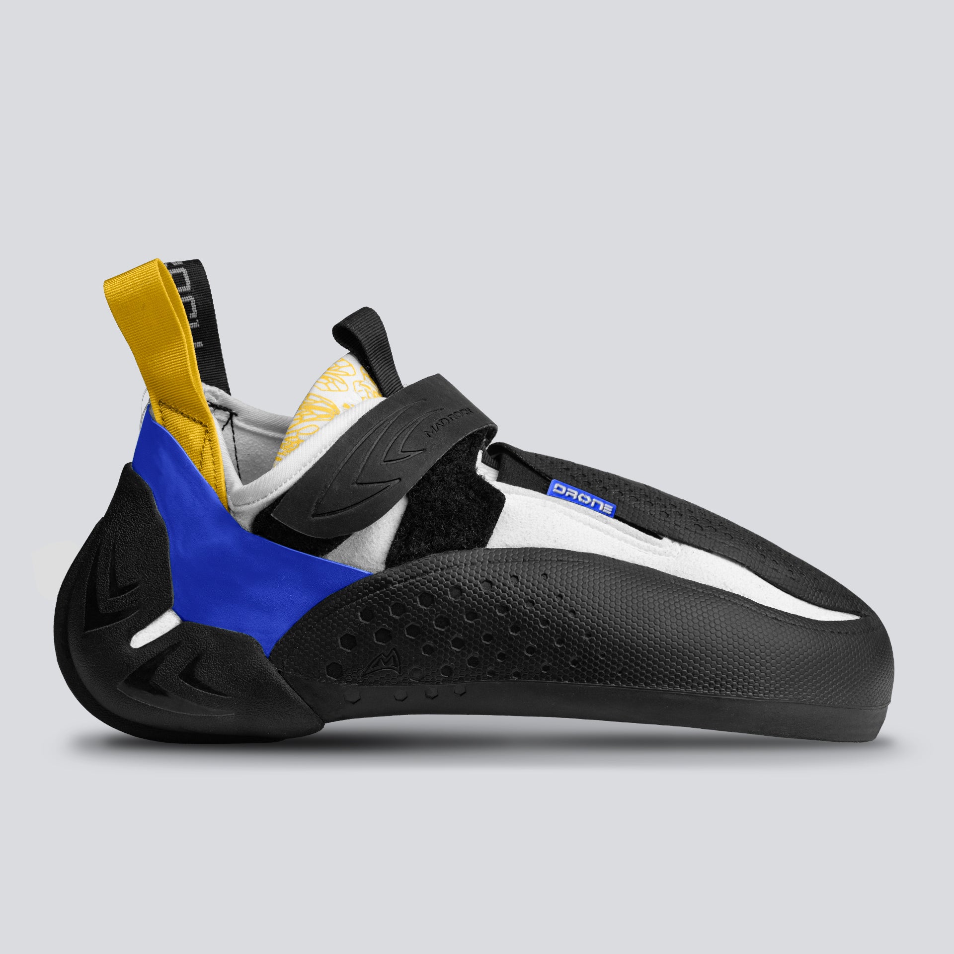Side view of a black, blue, and yellow climbing shoe on a gray background