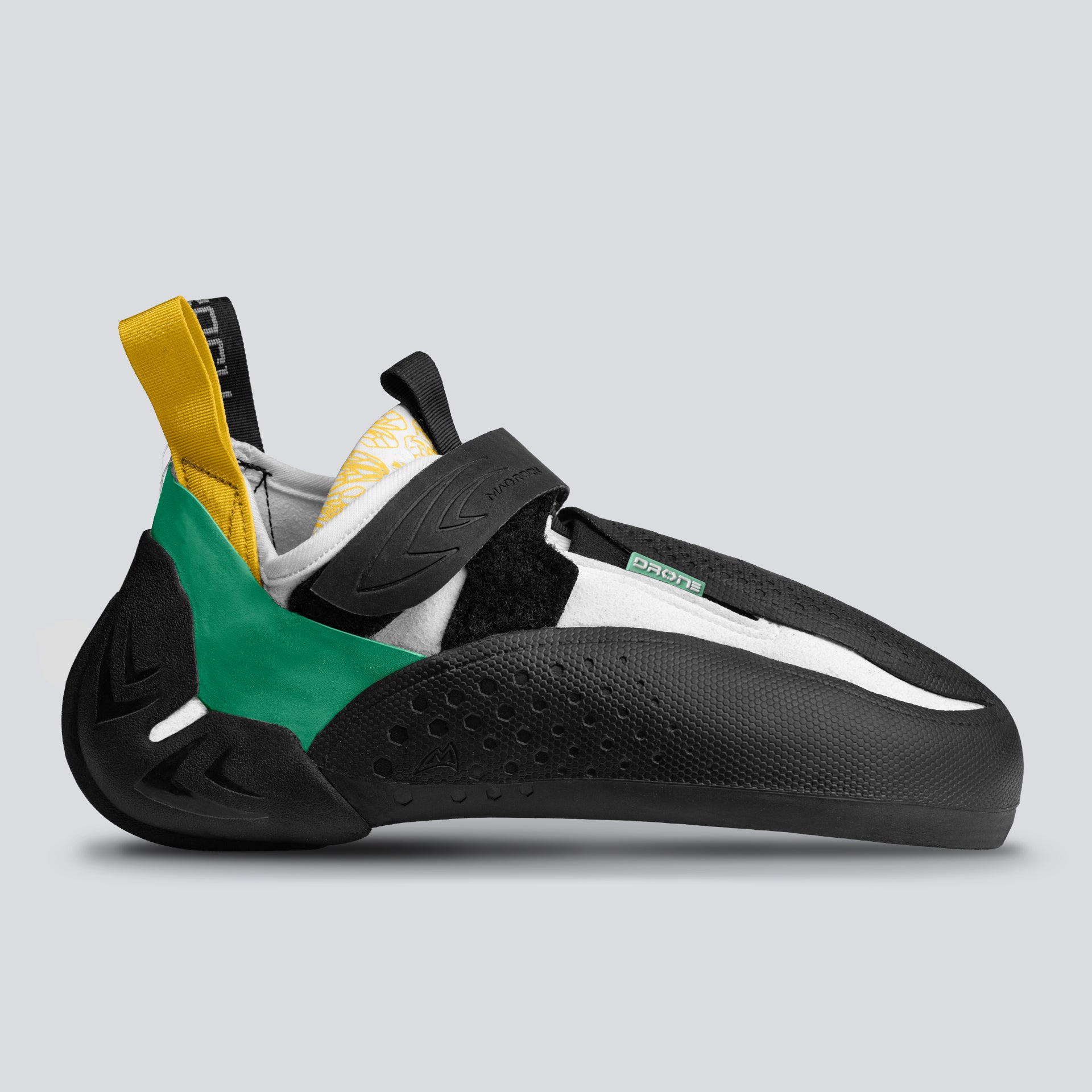 A side view of a climbing shoe with green, black, and yellow design on a gray background