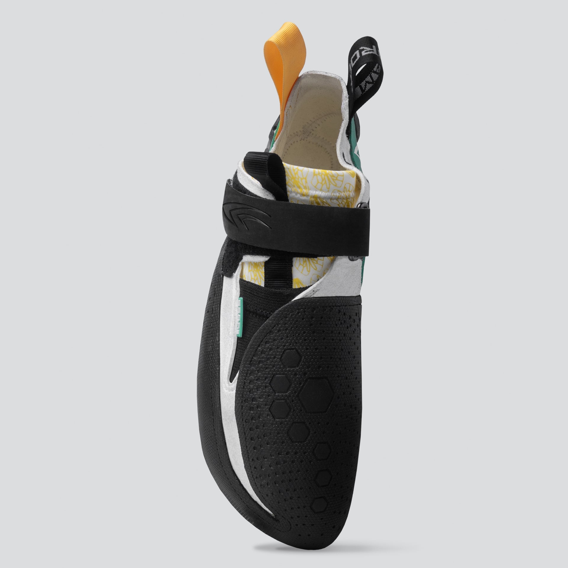 Black climbing shoe with white sole on a gray background