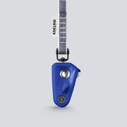Blue climbing device with gray strap on a light gray background