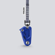 Blue climbing device with a gray strap on a light gray background