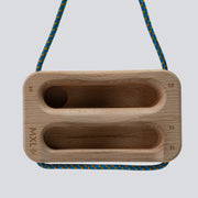 Wooden training tool with a cord on a light gray background