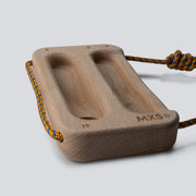 Wooden training tool with a cord on a light gray background