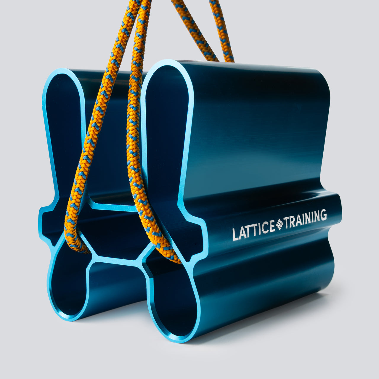 A blue metallic pinch training tool with an orange cord running through it