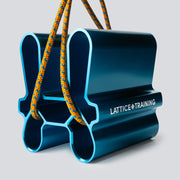 A blue metallic pinch training tool with an orange cord running through it