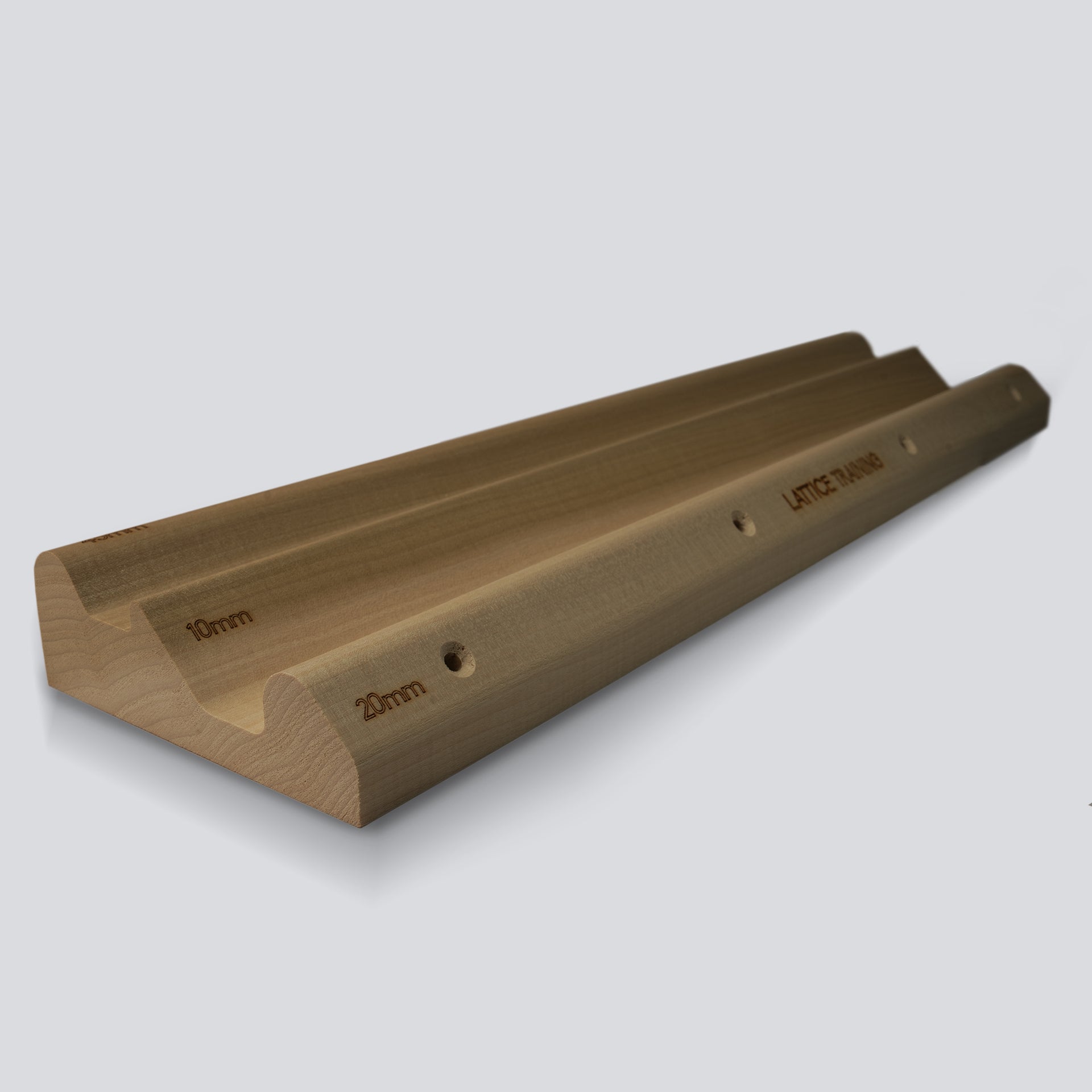 An angled view of a wooden hangboard with 3 different edges on a grey background