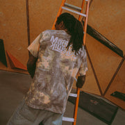 athlete Mickael Mawem wearing an acid wash shirt and facing away from the camera