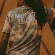 athlete Mickael Mawem wearing an acid wash shirt facing away from the camera