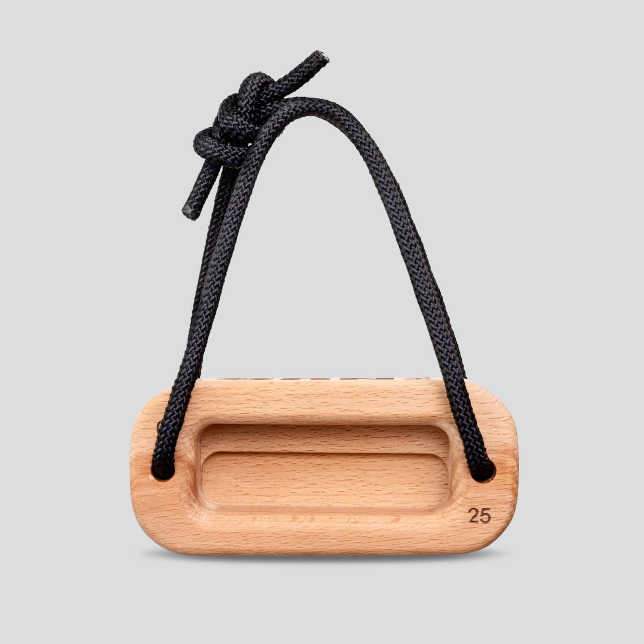 Wooden training block with a black cord on a light gray background