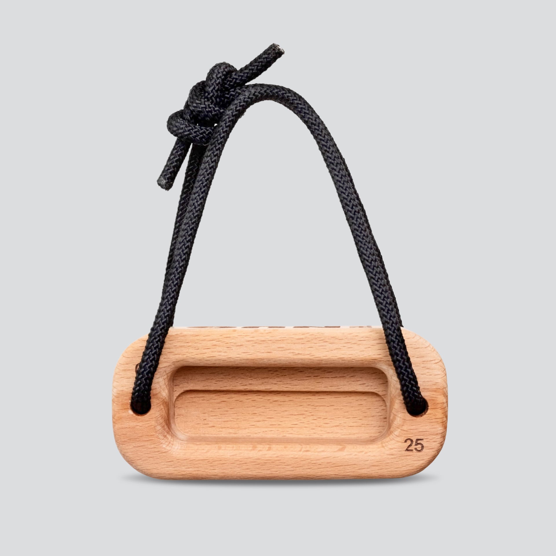 Wooden training block with a black cord on a light gray background