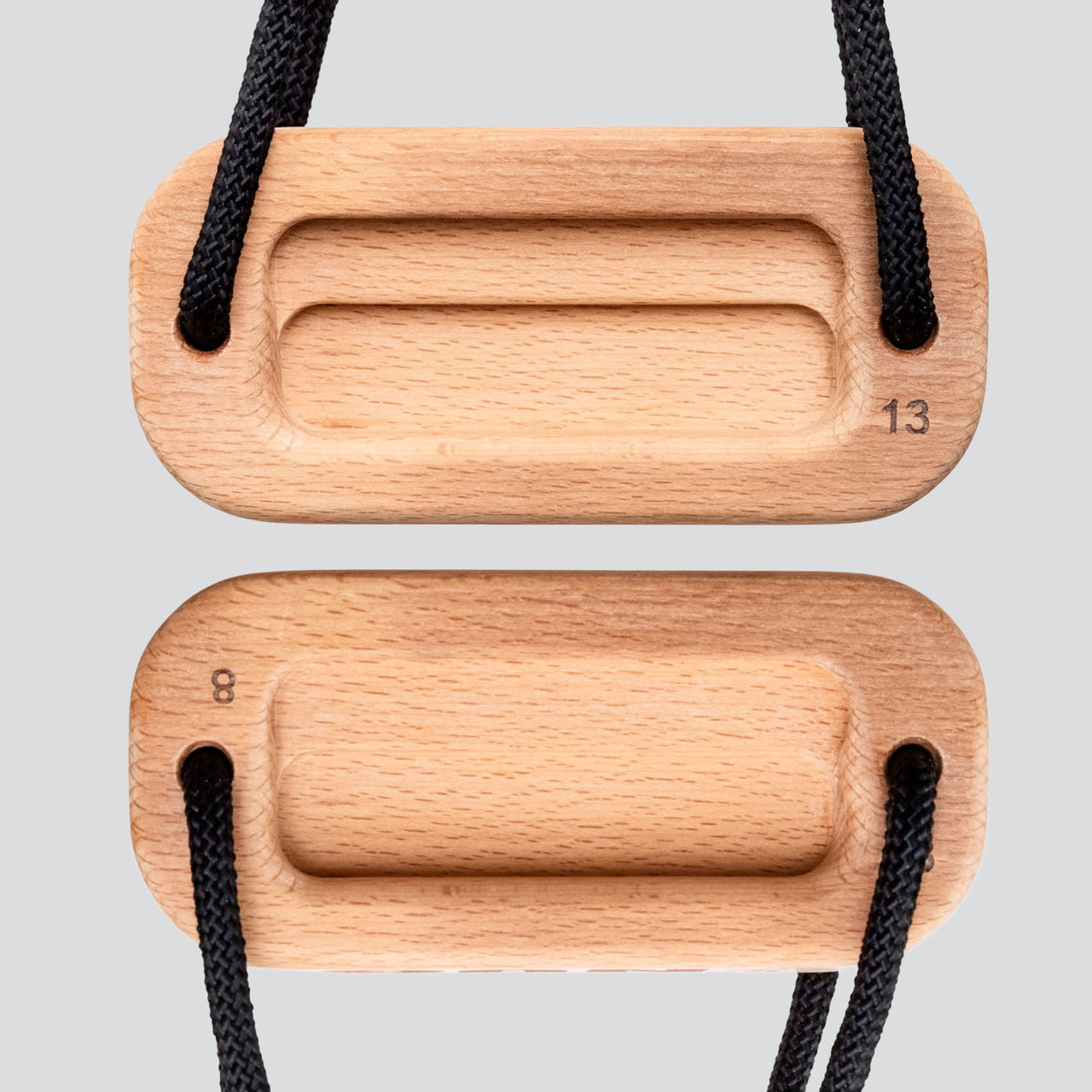 A view of a wooden training block highlighting the 8 millimeter edge depth and 13 millimeter edge depth with a black cord on a light gray background