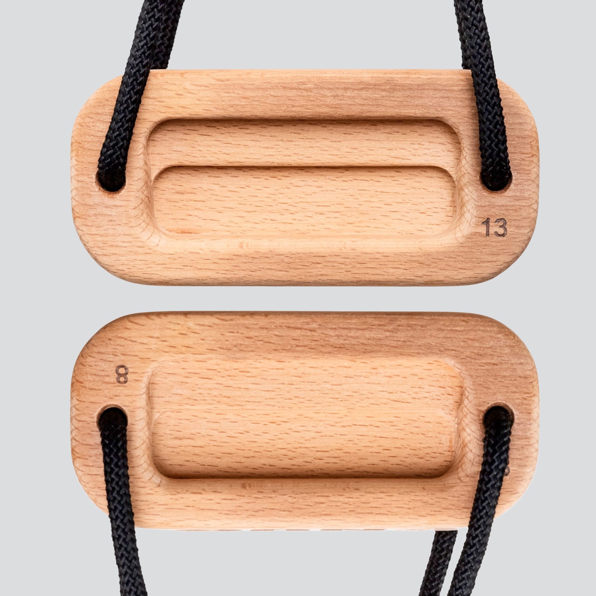 A view of a wooden training block highlighting the 8 millimeter edge depth and 13 millimeter edge depth with a black cord on a light gray background