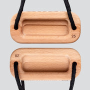 A view of a wooden training block highlighting the 25 millimeter edge depth and 20 millimeter edge depth with a black cord on a light gray background