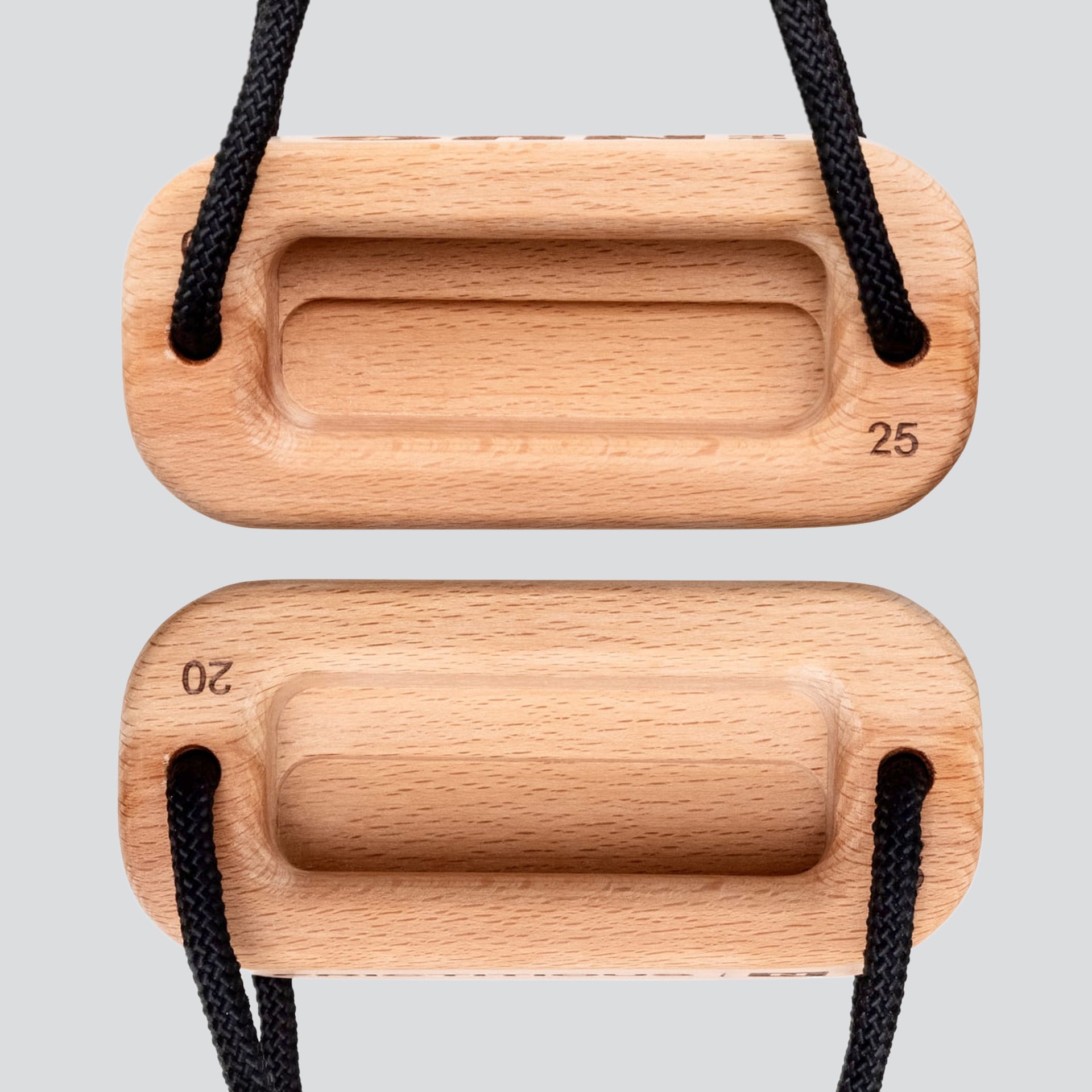A view of a wooden training block highlighting the 25 millimeter edge depth and 20 millimeter edge depth with a black cord on a light gray background