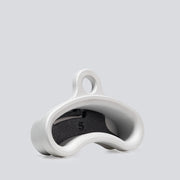 An isometric view of an aluminum finger training tool that has an ergonomic curved shape and an insert inside of it to change the edge depth.